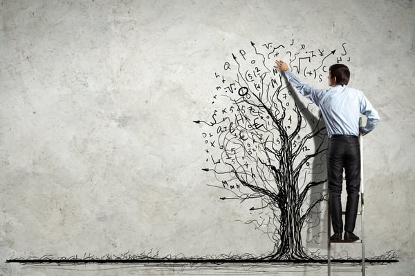 Back view image of businessman drawing graphics on wall