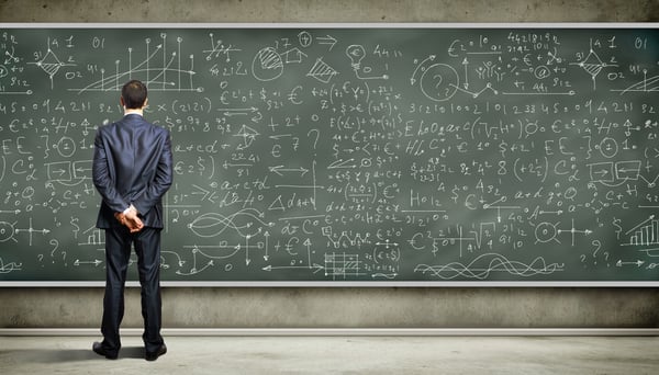 Business person standing against the blackboard with a lot of data written on it-1