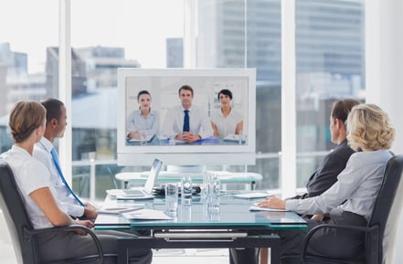 Business team having video conference with another business team in office-1