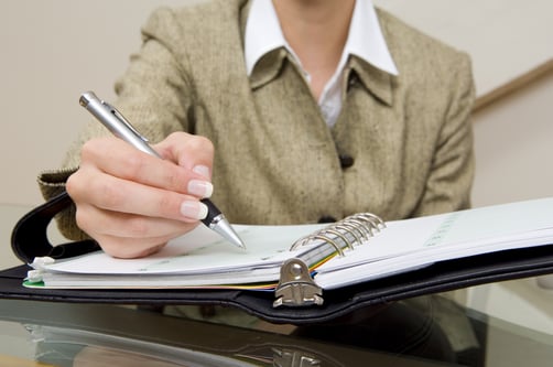 Close up of businesswoman with planner.