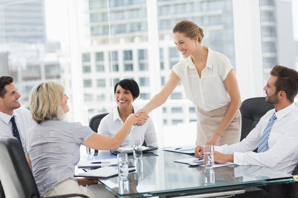 Side view of executives shaking hands during a business meeting in the office